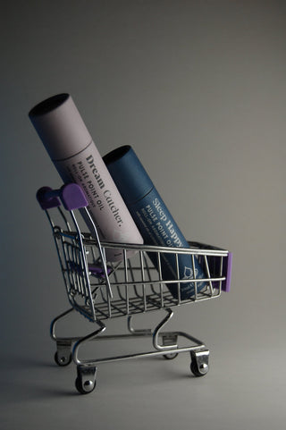 Osmology Dream Catcher and Sleep Happy Pulse Point Oils shown in a tiny shopping cart.