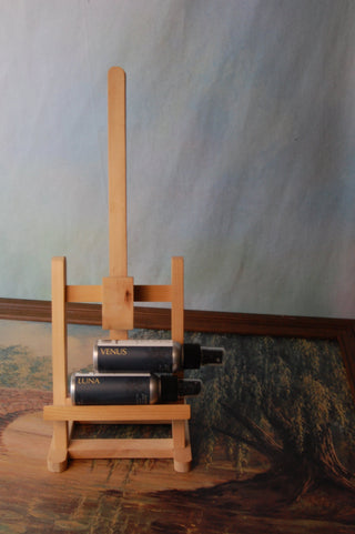 Magna Dea's Luna and Venus Pillow Spray set on a small easel. Background is a willow tree.
