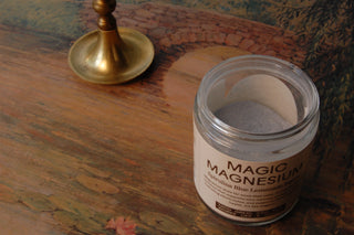 Opened jar of magic magnesium, showing the light blue spirulina powder.