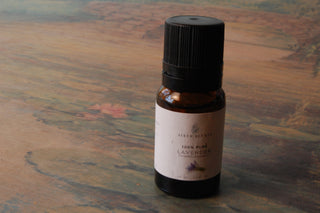 An amber bottle of 100% pure lavender essential oil by Sixth Scents. 