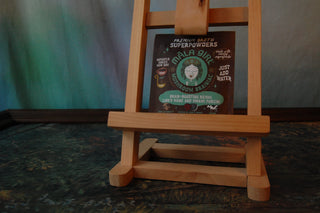 Packet of Mala Girl Mushroom Brainiac broth sitting on an easel.