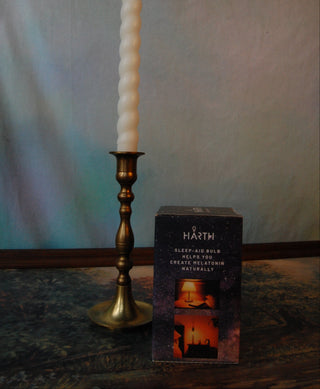 Harth Amber Light Bulb packaging that says "sleep-aid bulb helps you create melatonin naturally" next to a candlestick.