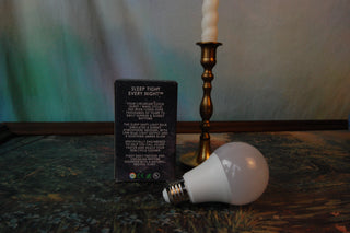 Harth Amber Light Bulb shown next to its packaging describing the sleep shift light bulb.
