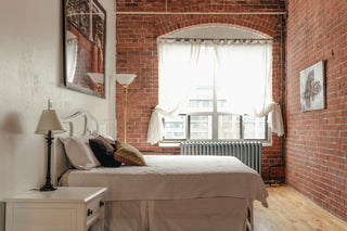 Loft with exposed brink bedroom with great lighting.